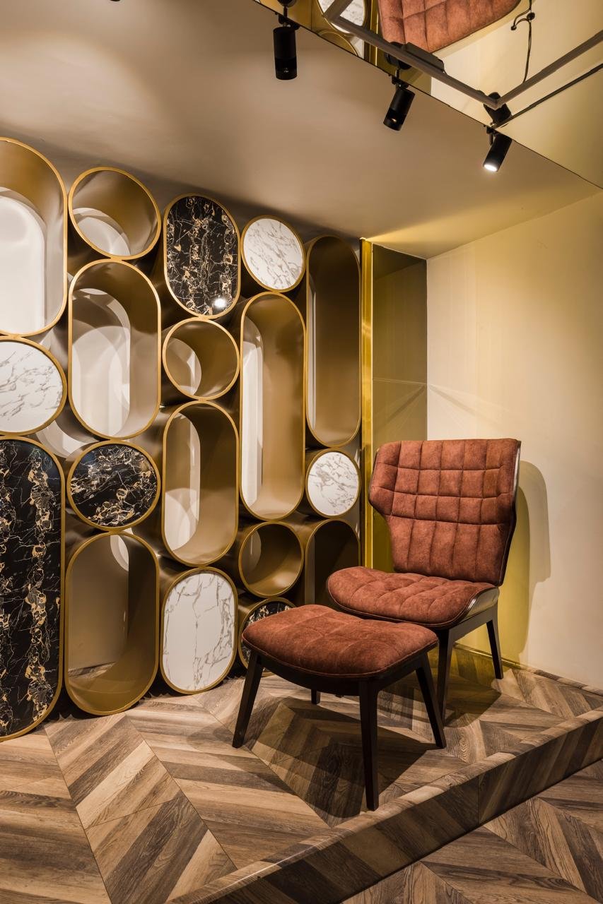 Accent chair next to a wall of round decorative mirrors